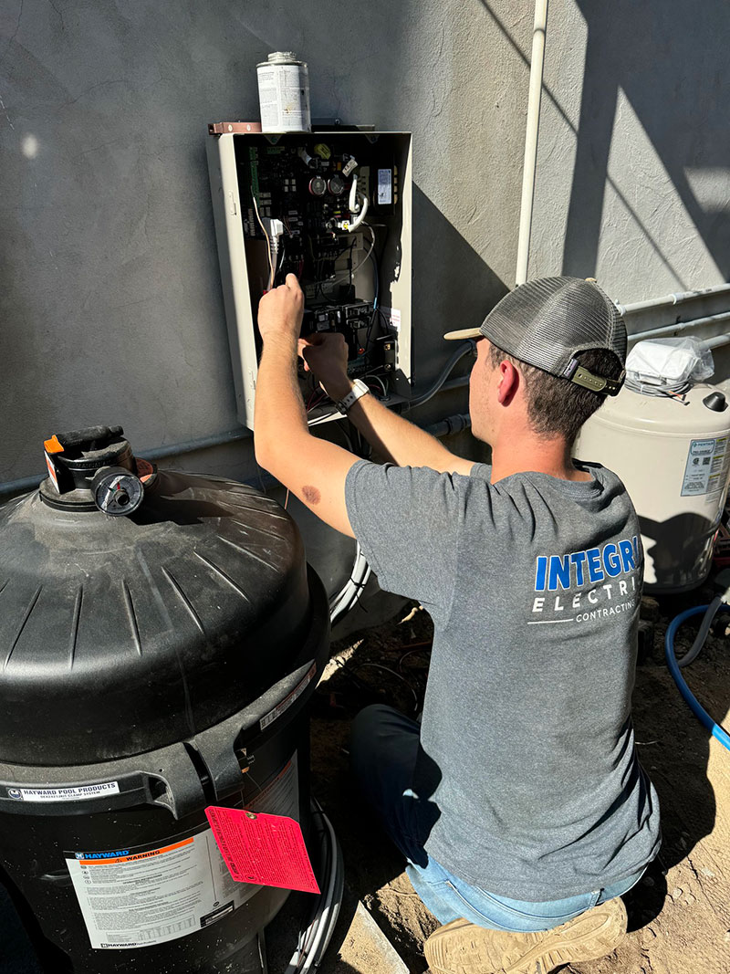 pool installation electrician, Skilled electrician testing circuits and inspecting panel connections for system reliability