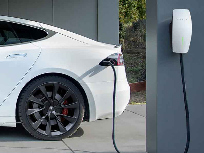 ev charger installation repair, Experienced electrician testing EV charger circuit with meter after code-compliant installation